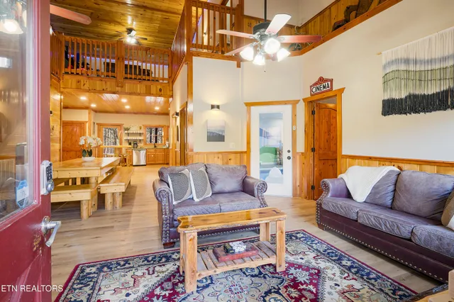 a living room with furniture a flat screen tv and a fireplace
