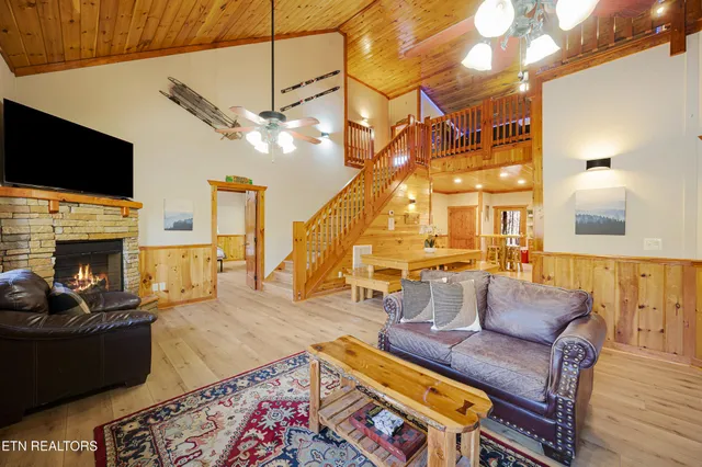 a living room with furniture a fireplace and a flat screen tv