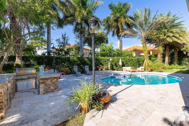 a kitchen with stainless steel appliances a sink stove and cabinets