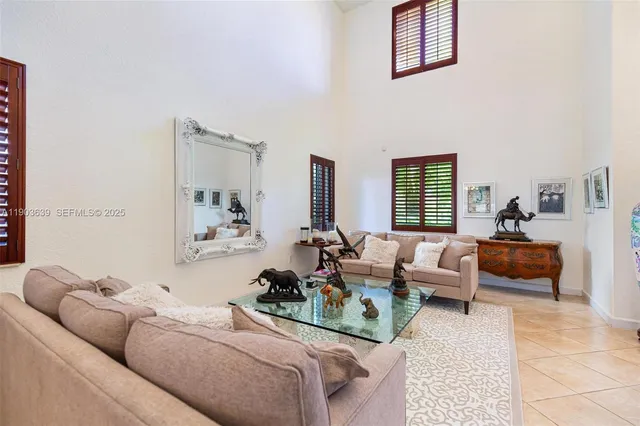 a dining room with furniture a chandelier and window