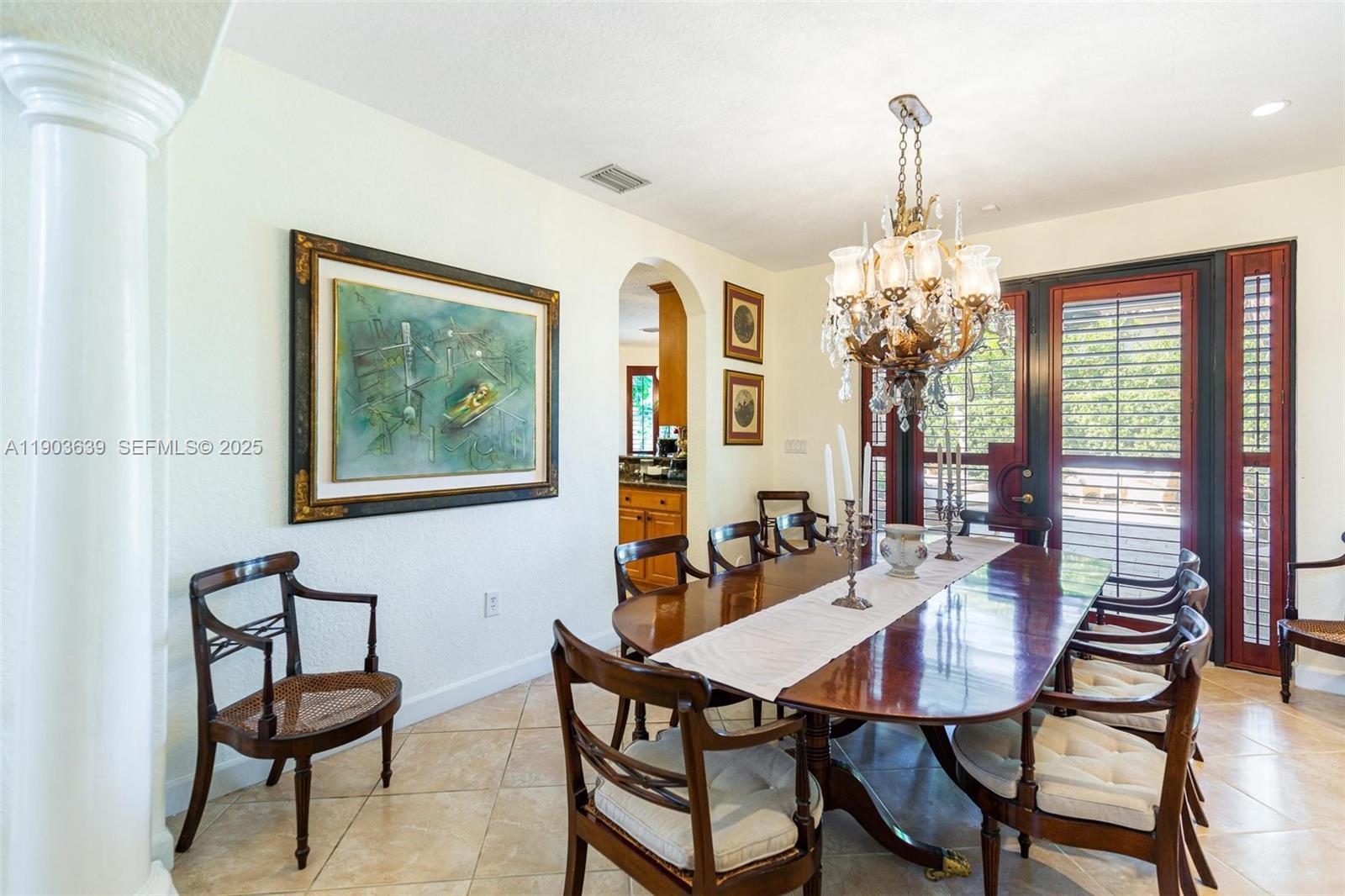 7587 Southwest 189th Street Cutler Bay, FL 33157 - Photo 21 of 66 a dining room with furniture a chandelier and window