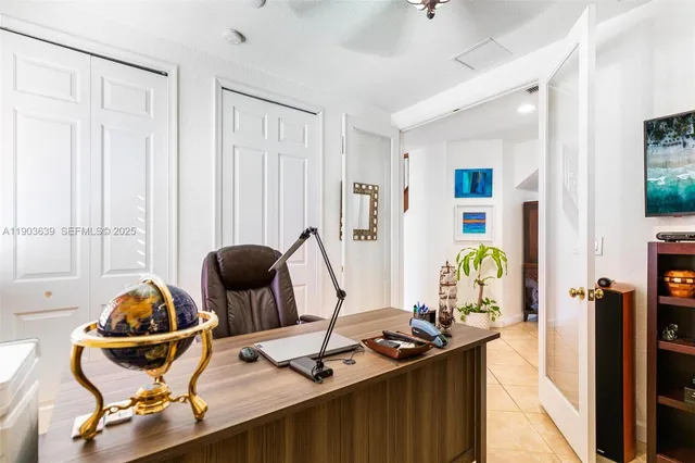 a bedroom with a bed and a chandelier fan