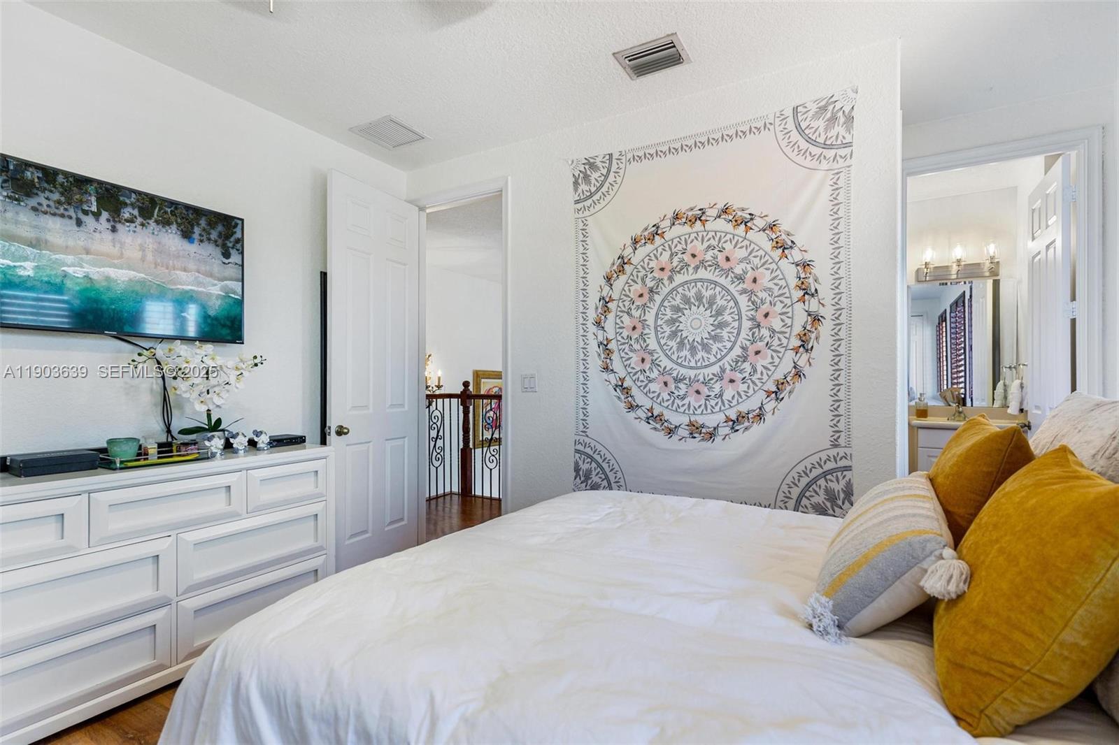 7587 Southwest 189th Street Cutler Bay, FL 33157 - Photo 30 of 66 a bedroom with a bed and a flat screen tv