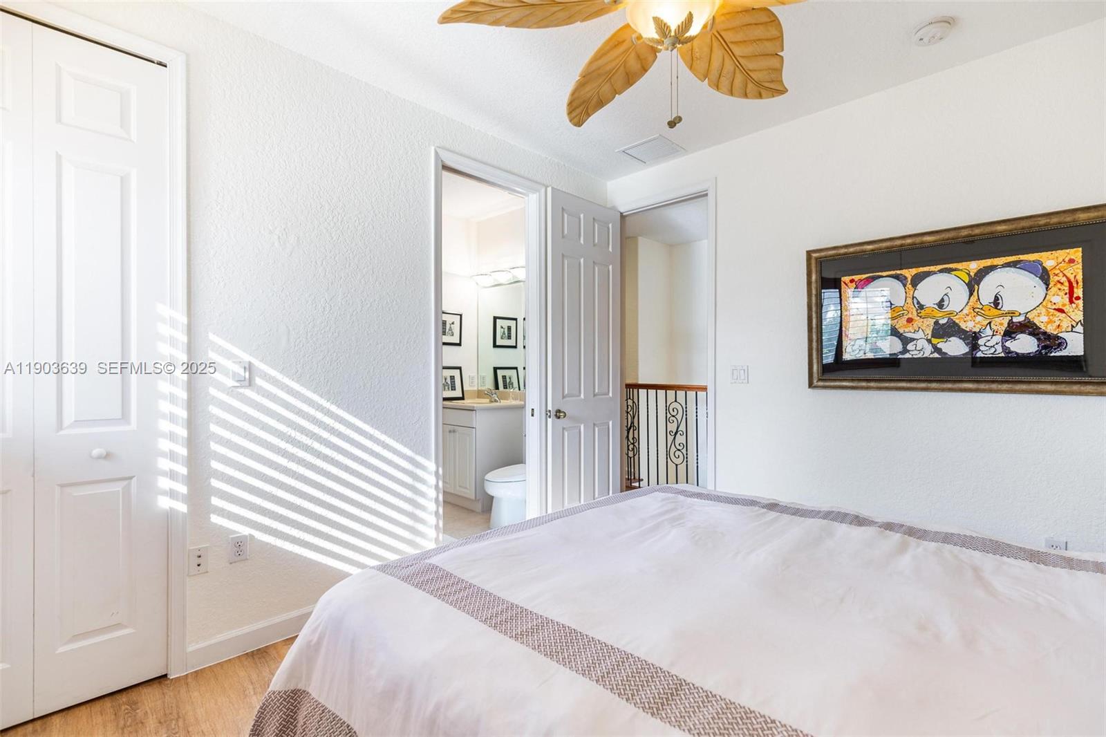 7587 Southwest 189th Street Cutler Bay, FL 33157 - Photo 33 of 66 a bedroom with a bed and a painting on the wall