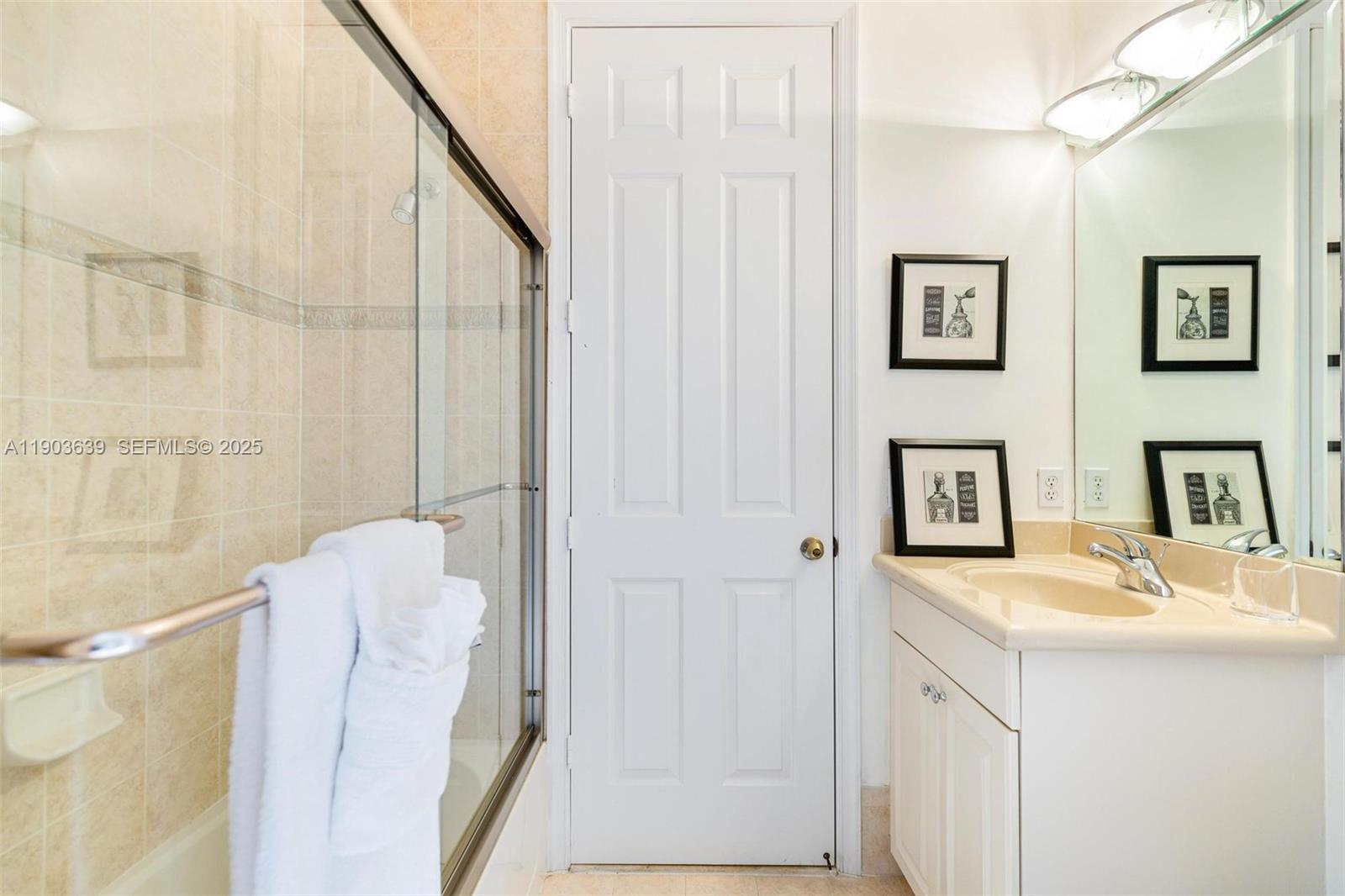 7587 Southwest 189th Street Cutler Bay, FL 33157 - Photo 34 of 66 a en suite bathroom with a sink and mirror