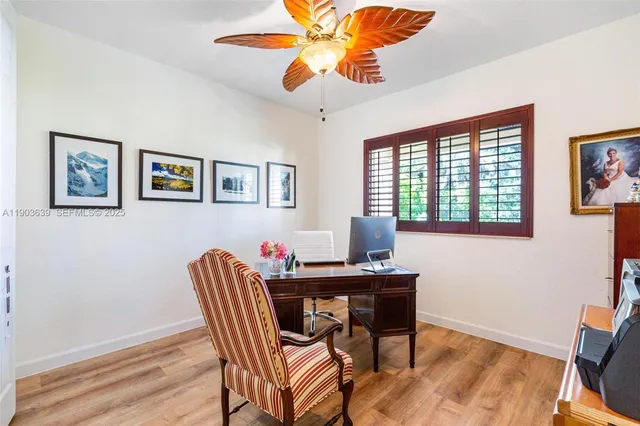 a living room with furniture a flat screen tv and kitchen view