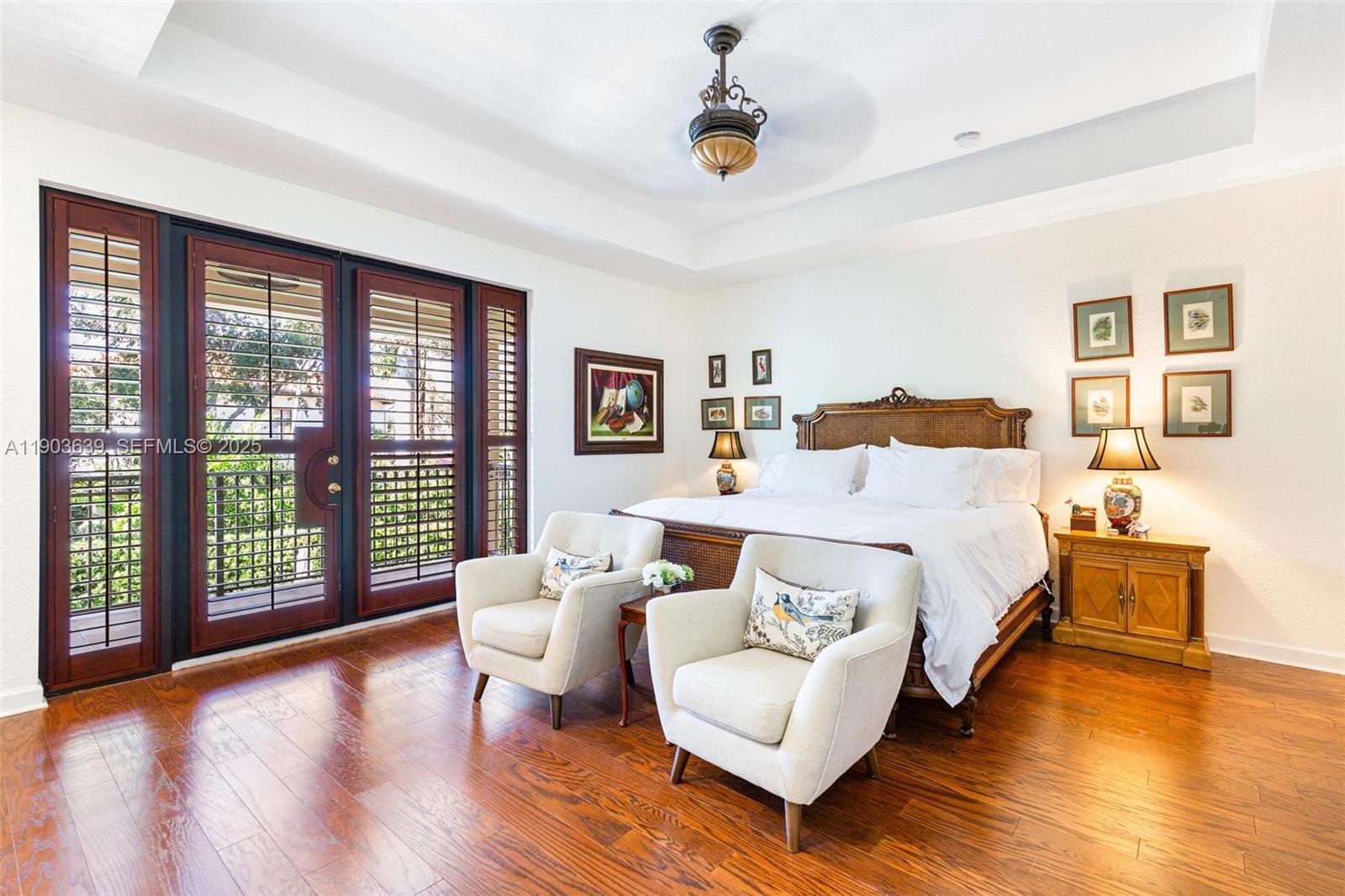 7587 Southwest 189th Street Cutler Bay, FL 33157 - Photo 38 of 66 a spacious bedroom with a bed and wooden floor