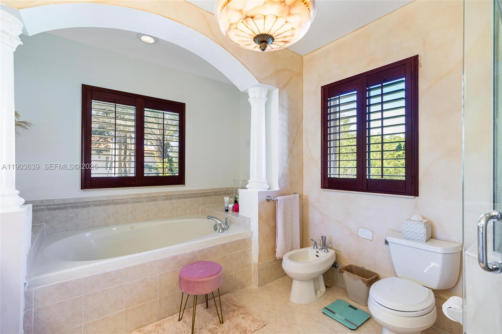 7587 Southwest 189th Street Cutler Bay, FL 33157 - Photo 42 of 66 a bathroom with a toilet a sink and bathtub