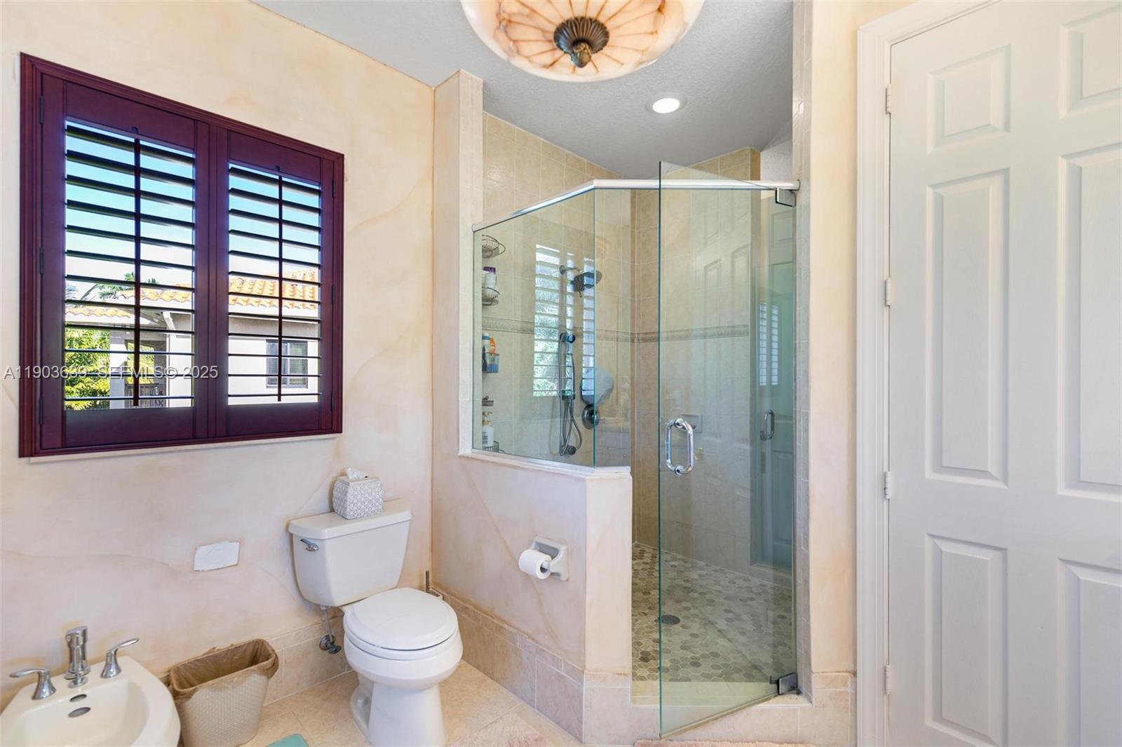 7587 Southwest 189th Street Cutler Bay, FL 33157 - Photo 43 of 66 a bathroom with a granite countertop sink toilet and shower