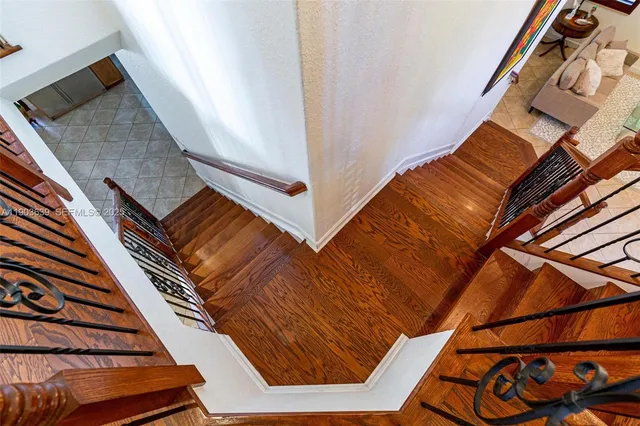 a view of a room with gym equipment and wooden floor