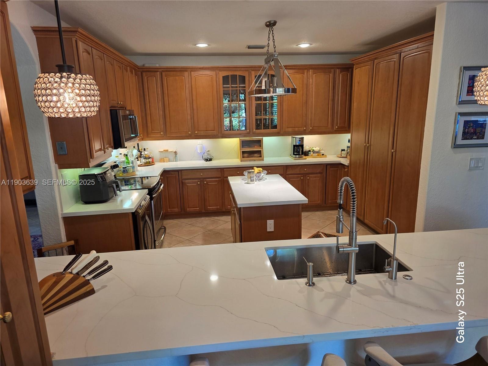 7587 Southwest 189th Street Cutler Bay, FL 33157 - Photo 50 of 66 a living room with furniture a flat screen tv and kitchen view