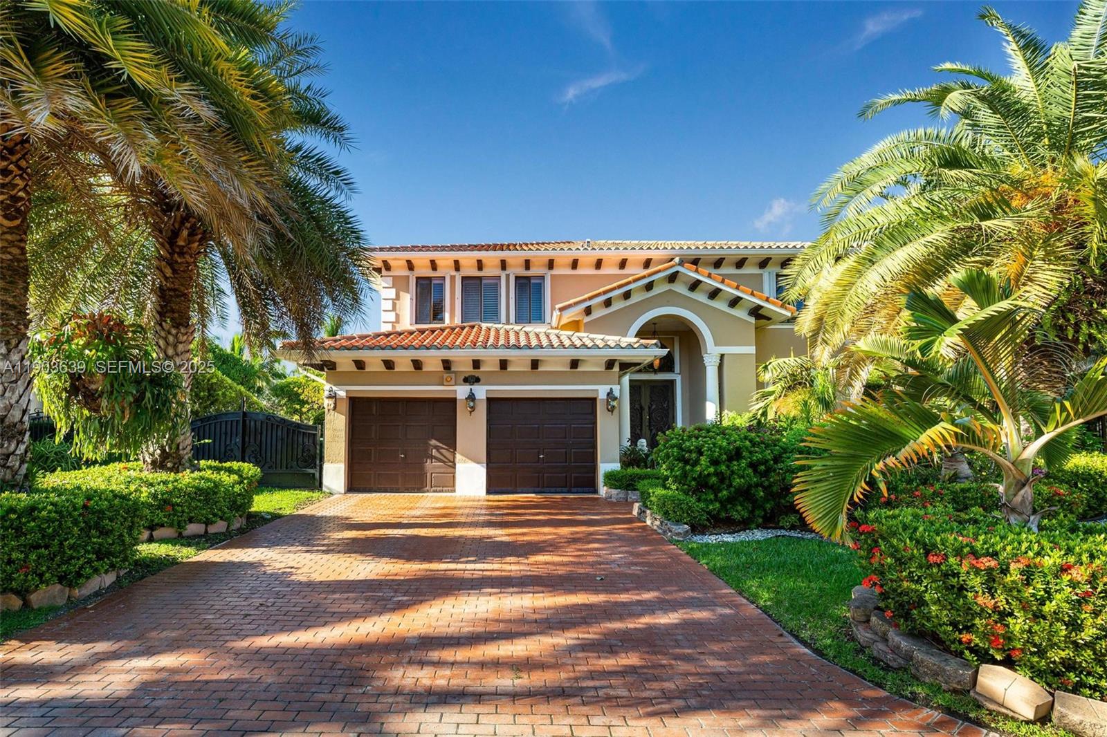 7587 Southwest 189th Street Cutler Bay, FL 33157 - Photo 54 of 66 a front view of a house with a garden