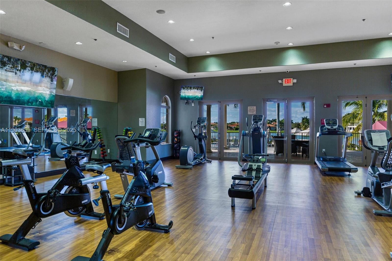 7587 Southwest 189th Street Cutler Bay, FL 33157 - Photo 64 of 66 a view of a room with gym equipment and wooden floor
