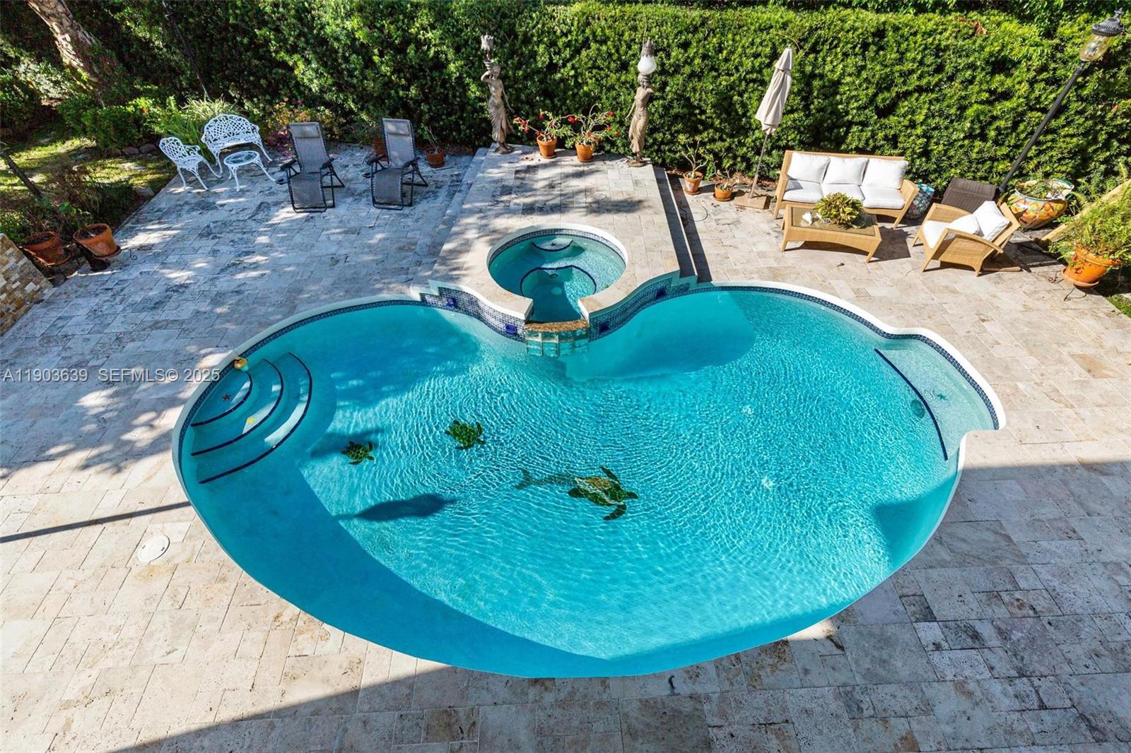 7587 Southwest 189th Street Cutler Bay, FL 33157 - Photo 9 of 66 a view of a swimming pool with a sitting space