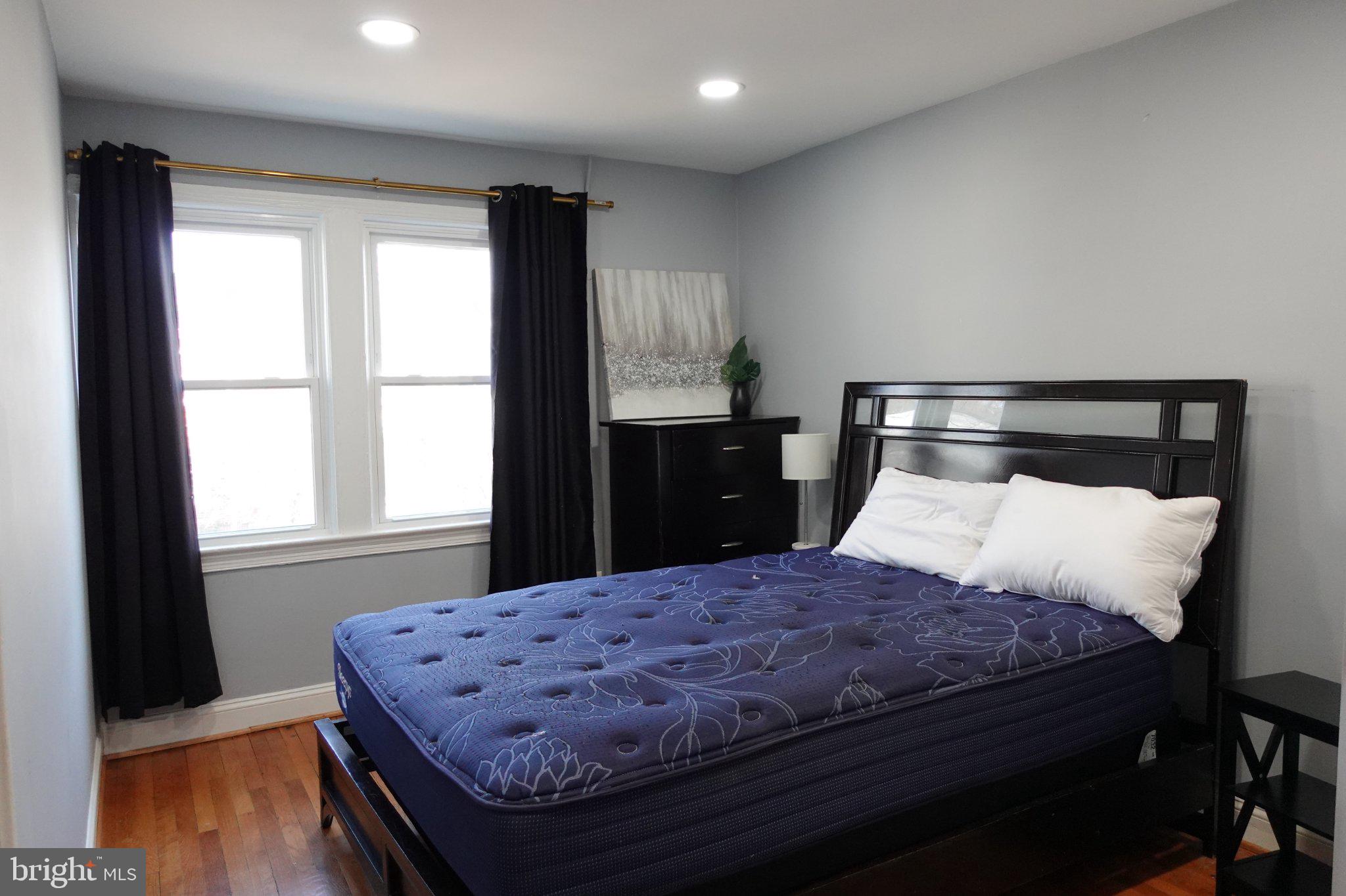 1228 18th Street Northeast Washington, DC 20002 - Photo 2 of 11 a bedroom with a bed and wooden floor