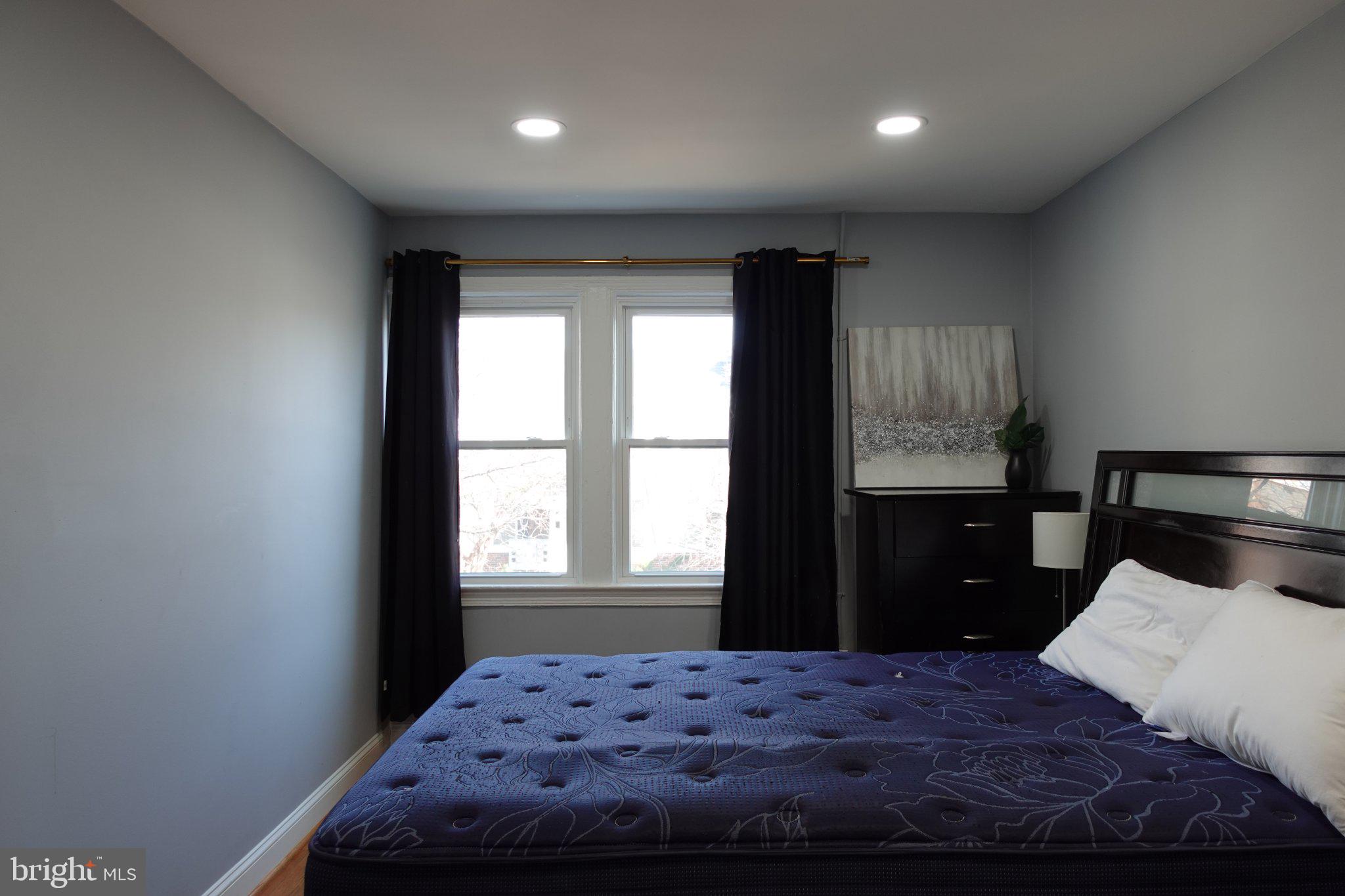 1228 18th Street Northeast Washington, DC 20002 - Photo 3 of 11 a bedroom with a large bed and a window