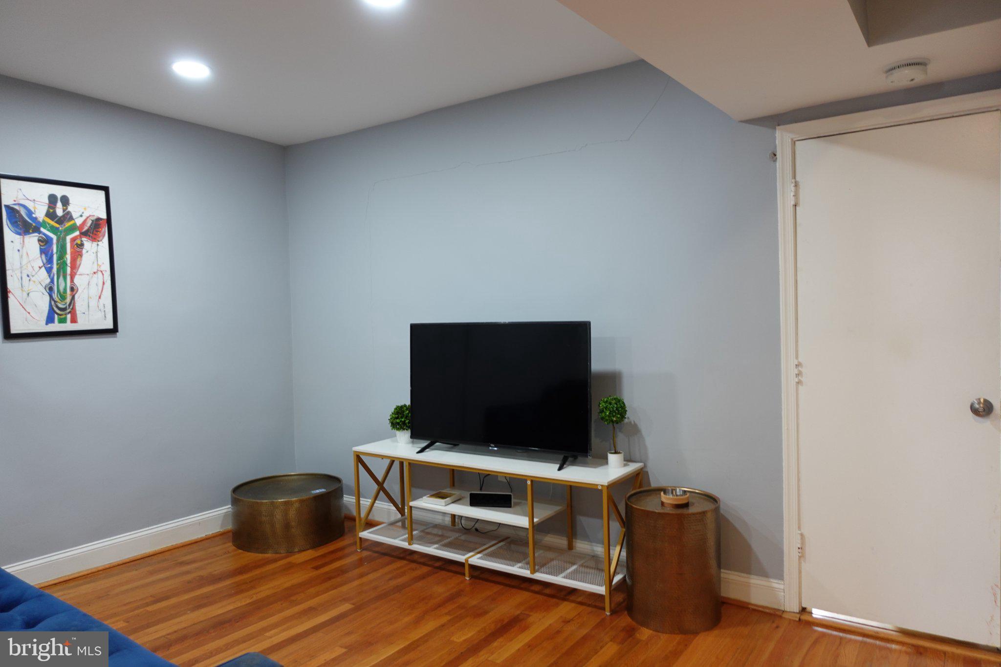 1228 18th Street Northeast Washington, DC 20002 - Photo 7 of 11 a living room with furniture and a flat screen tv