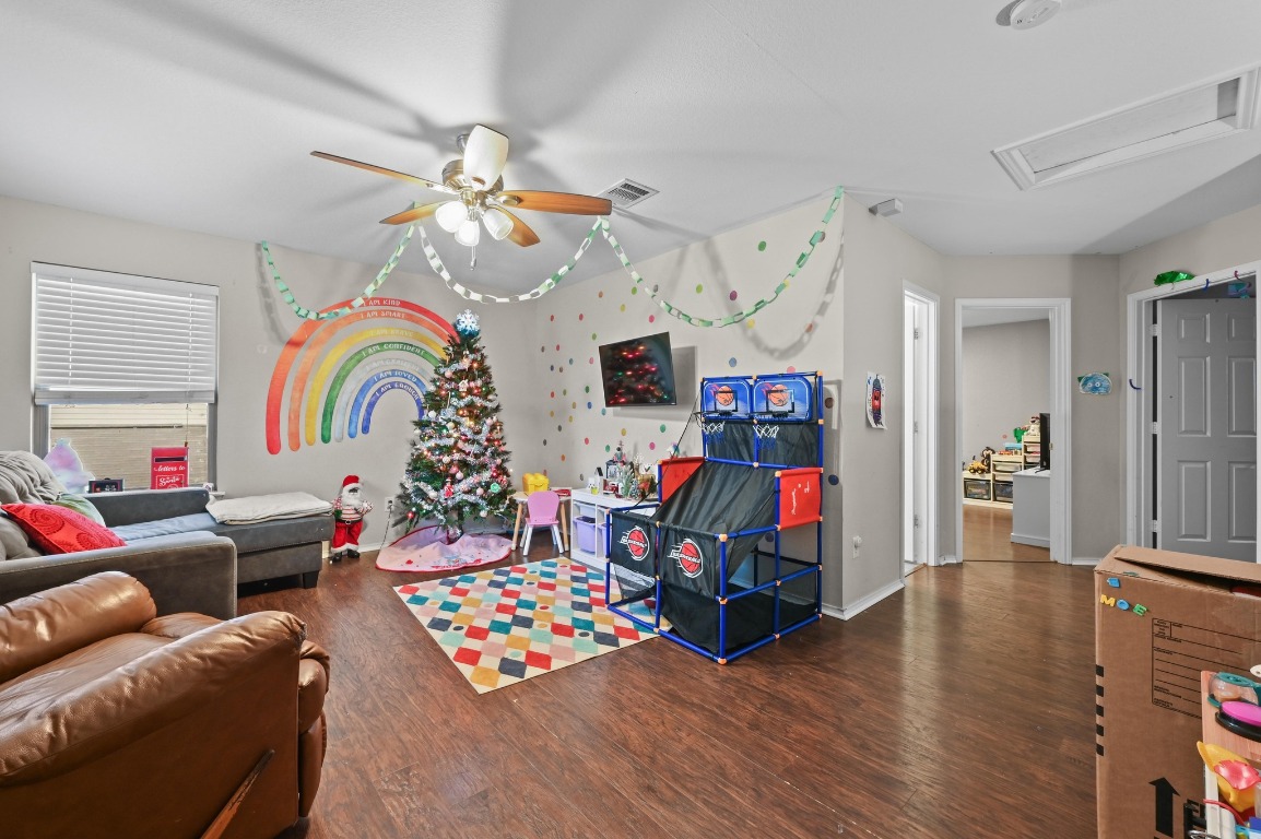 6624 Quinton Drive Austin, TX 78747 - Photo 13 of 25 a bedroom with furniture and wooden floor