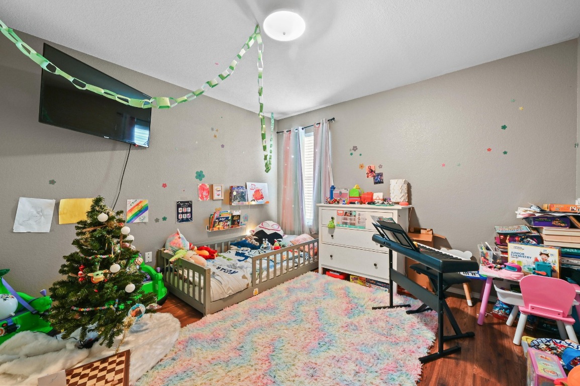 6624 Quinton Drive Austin, TX 78747 - Photo 20 of 25 a playing room with furniture and a chandelier