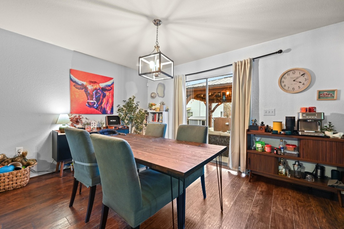 6624 Quinton Drive Austin, TX 78747 - Photo 7 of 25 a view of a dining room with furniture a chandelier and wooden floor