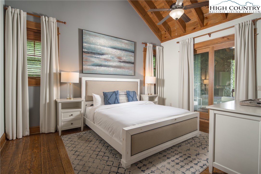 153 Stonecrop Lane Boone, NC 28607 - Photo 15 of 49 a bedroom with a bed and a large window with balcony view