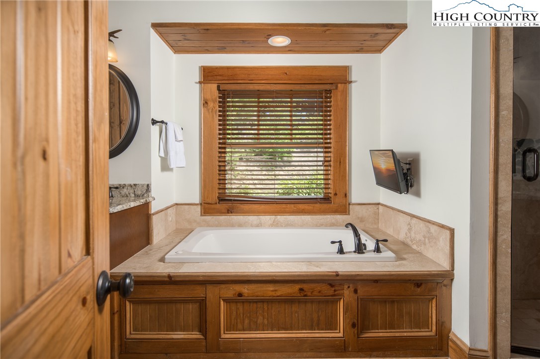 153 Stonecrop Lane Boone, NC 28607 - Photo 17 of 49 a bathroom with a granite countertop sink and a mirror