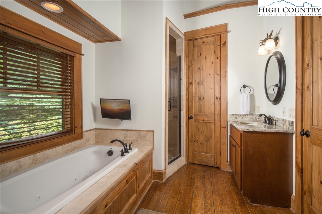 153 Stonecrop Lane Boone, NC 28607 - Photo 19 of 49 a bathroom with a tub sink and mirror