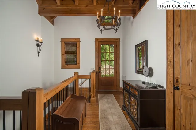 a living room with furniture a large window and a fireplace