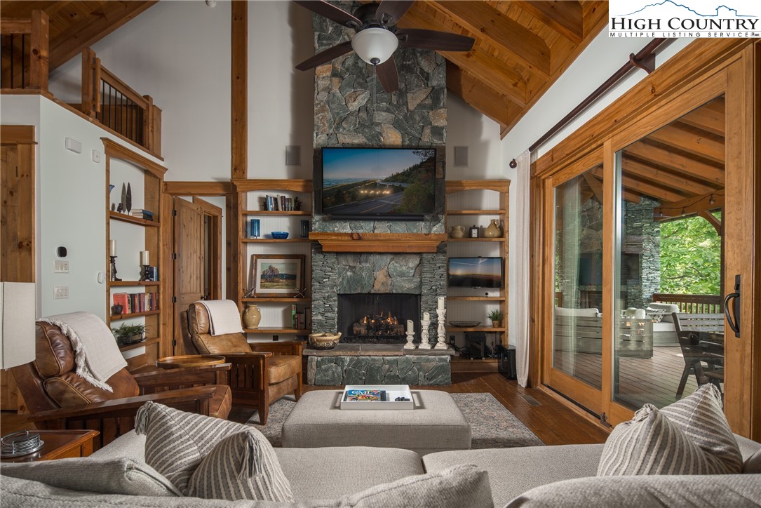 153 Stonecrop Lane Boone, NC 28607 - Photo 3 of 49 a living room with furniture a flat screen tv and a fireplace