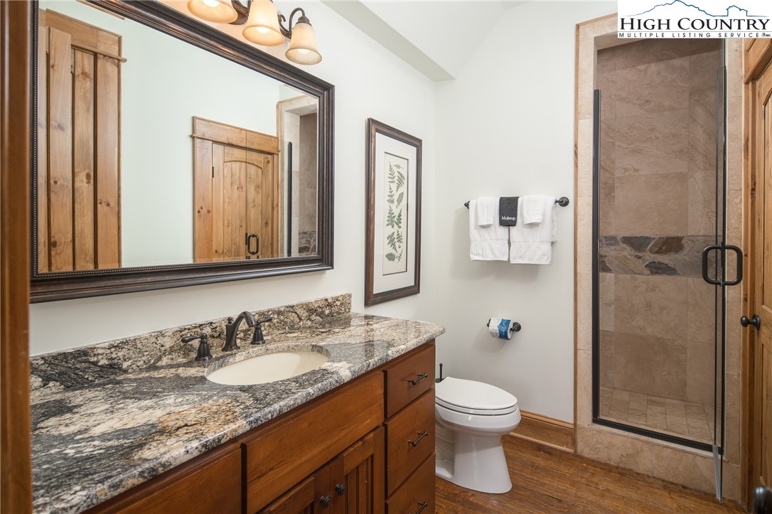153 Stonecrop Lane Boone, NC 28607 - Photo 31 of 49 a bathroom with a granite countertop sink toilet and shower