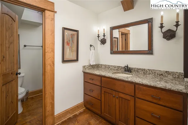 a bathroom with a granite countertop sink mirror and vanity