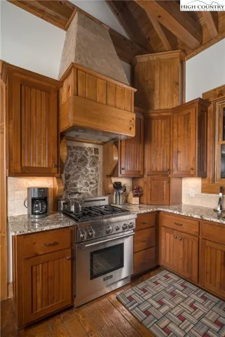a kitchen with stainless steel appliances granite countertop a stove and a refrigerator