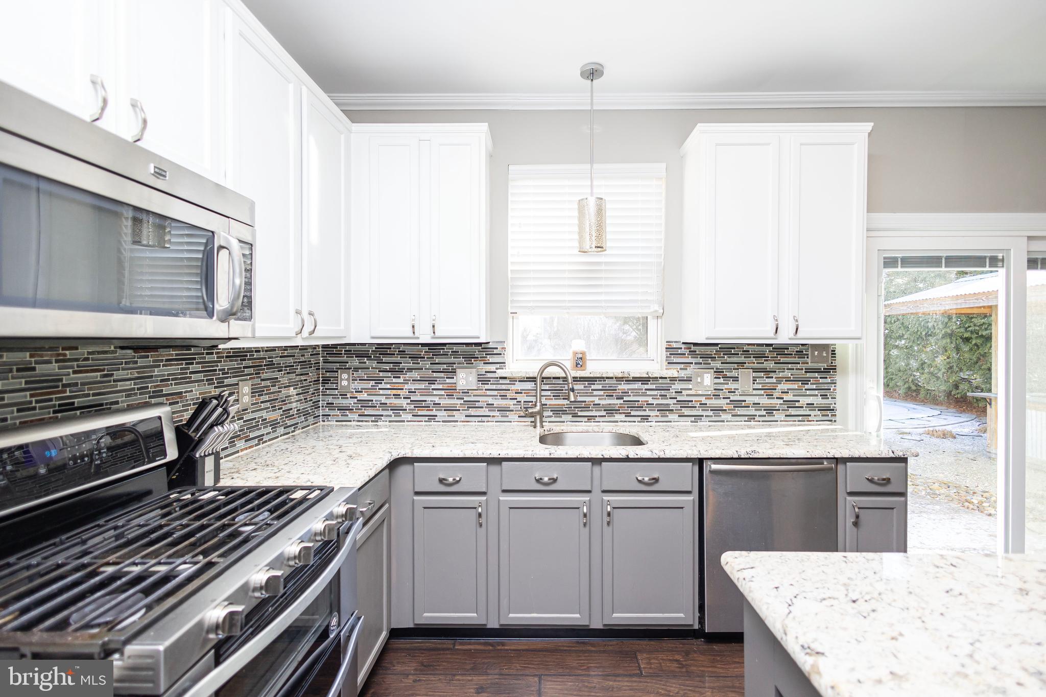 317 Pickwick Drive Williamstown, NJ 08094 - Photo 12 of 52 a kitchen with granite countertop a stove and a sink