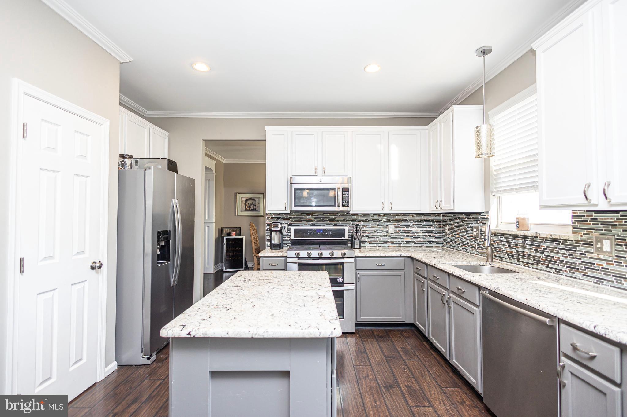 317 Pickwick Drive Williamstown, NJ 08094 - Photo 14 of 52 a kitchen with a sink stove and refrigerator