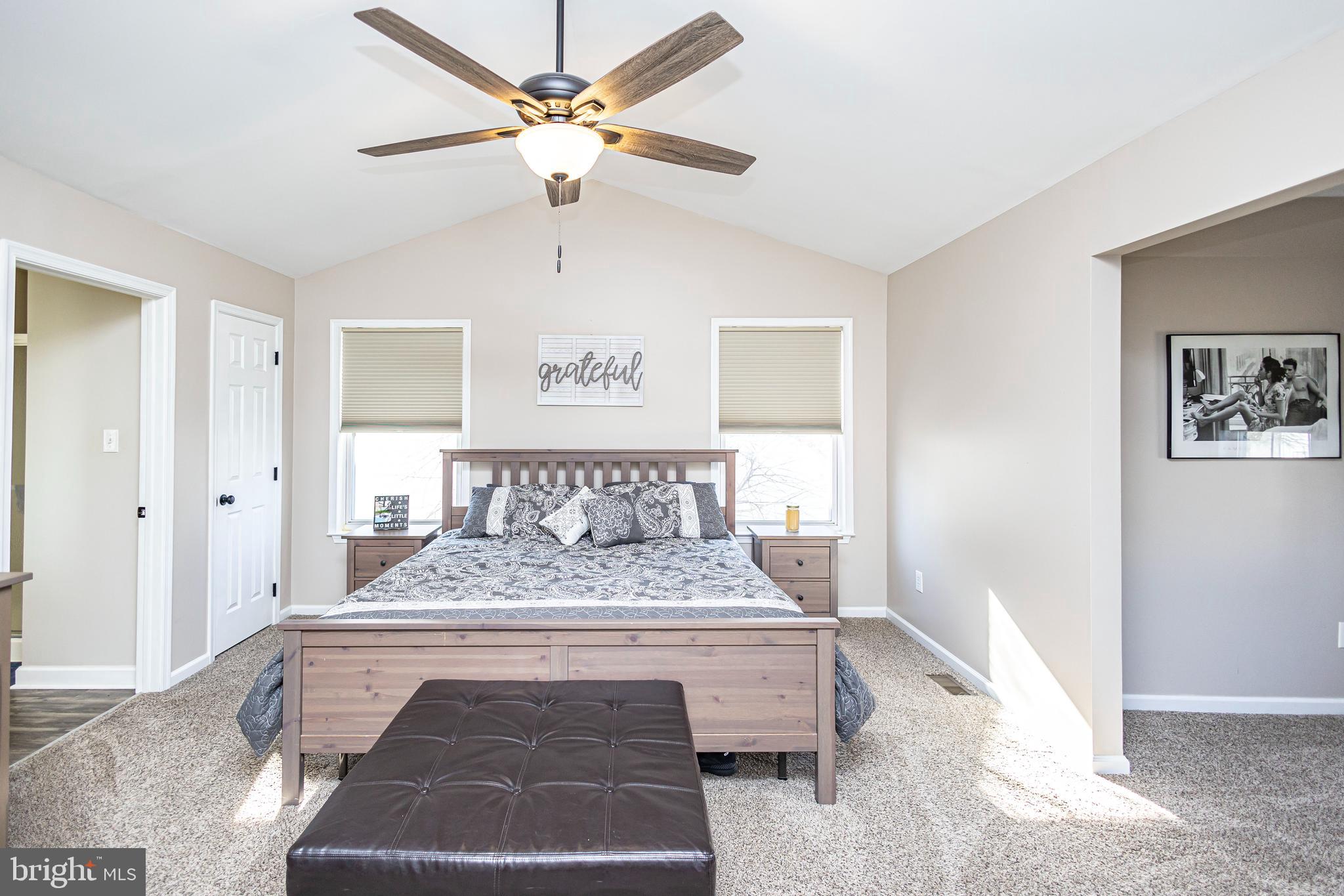 317 Pickwick Drive Williamstown, NJ 08094 - Photo 23 of 52 a bedroom with a large bed and a chandelier