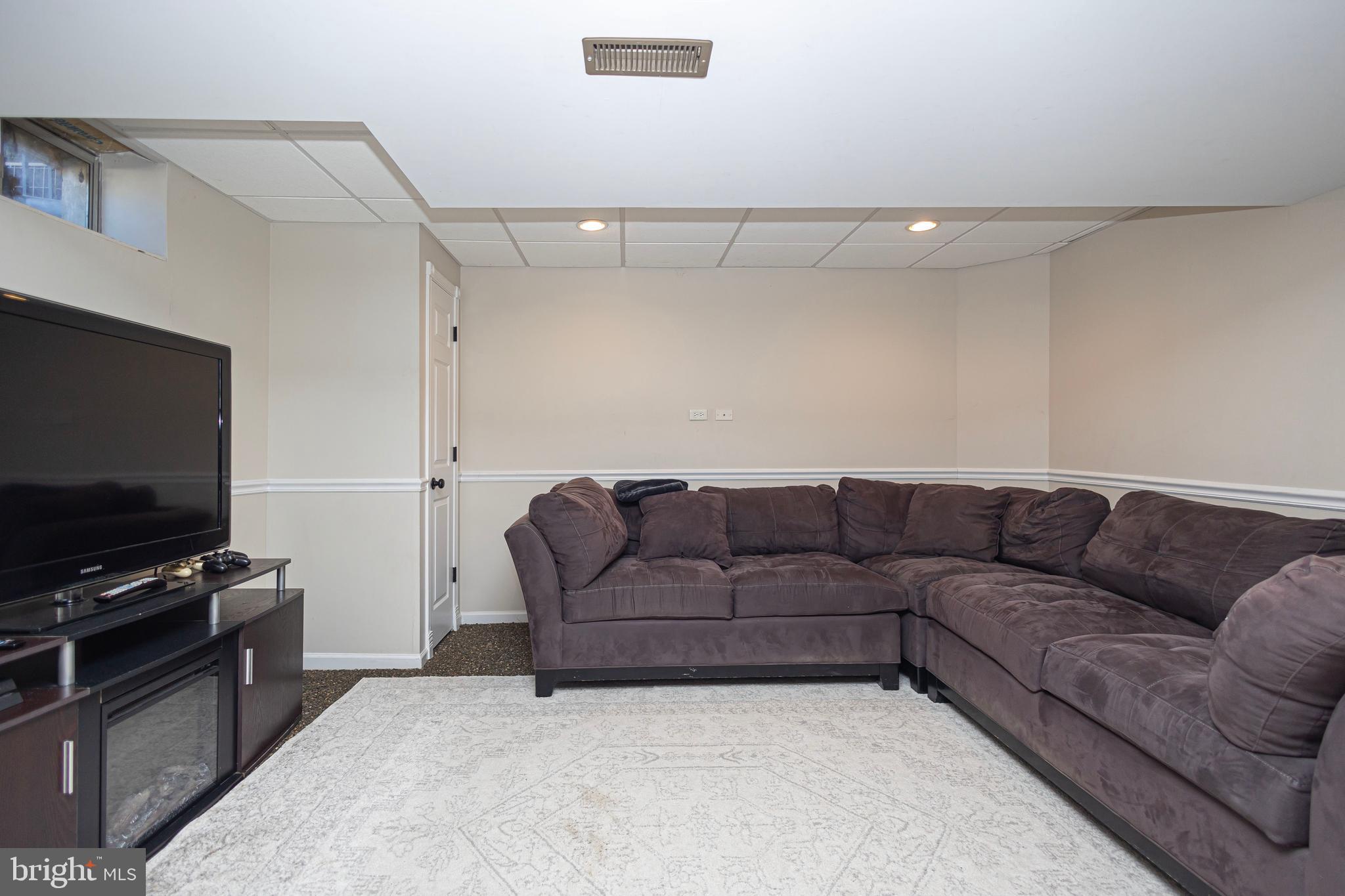 317 Pickwick Drive Williamstown, NJ 08094 - Photo 38 of 52 a living room with furniture and a flat screen tv