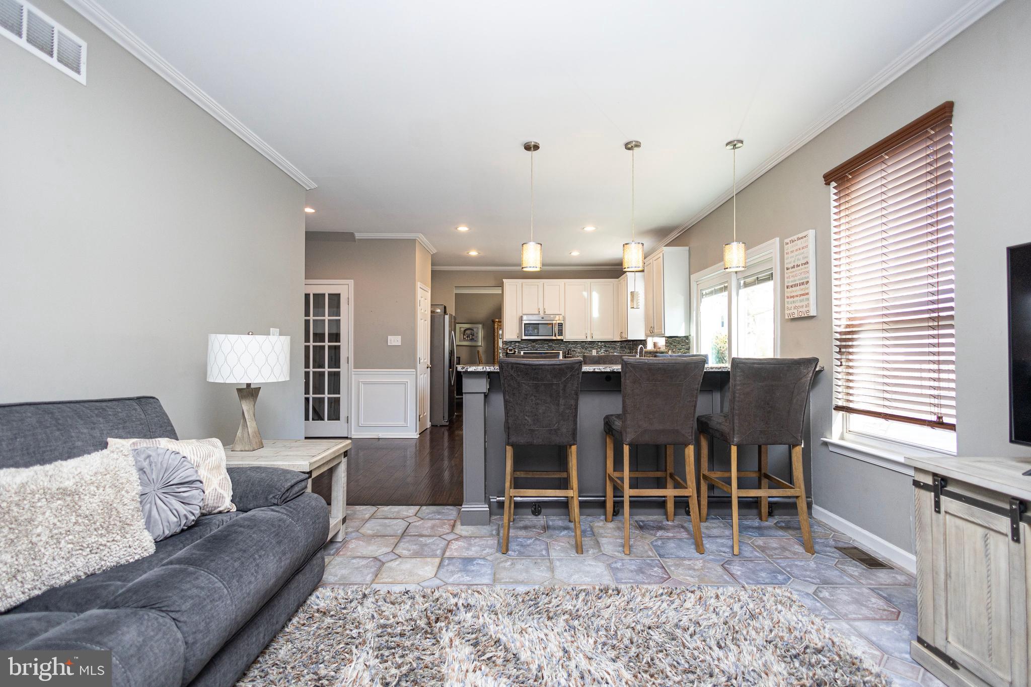 317 Pickwick Drive Williamstown, NJ 08094 - Photo 9 of 52 a living room with furniture a wooden floor and kitchen view