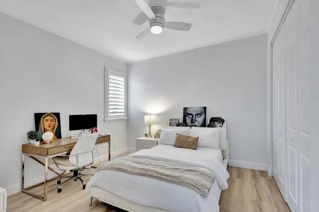 a front view of multi story residential apartment building with yard and green space