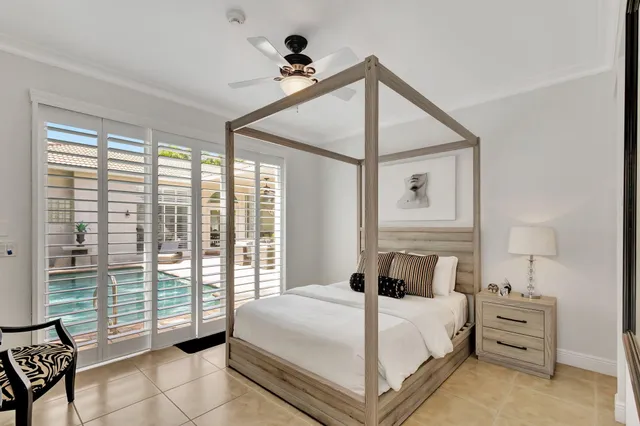a living room with hard wood flooring and chairs