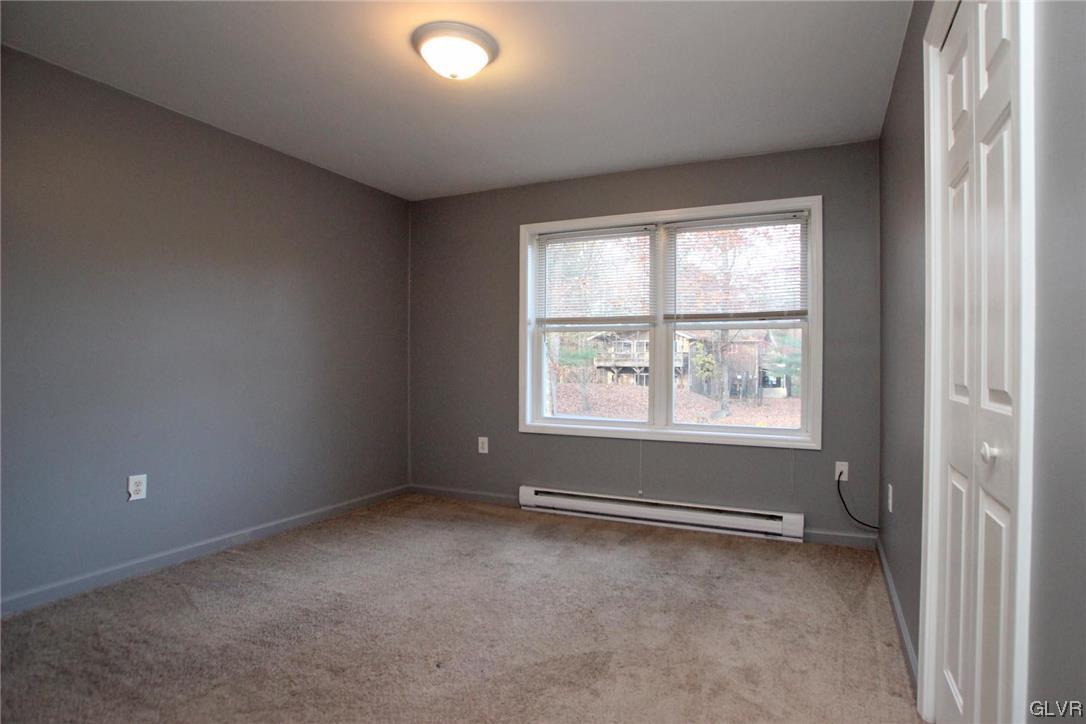 160 Spruce Drive Dingmans Ferry, PA 18328 - Photo 16 of 40 an empty room with windows and closet