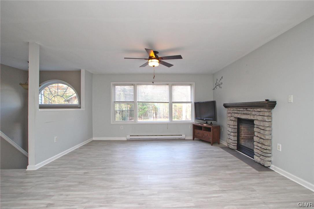 160 Spruce Drive Dingmans Ferry, PA 18328 - Photo 4 of 40 wooden floor in an empty room with a window