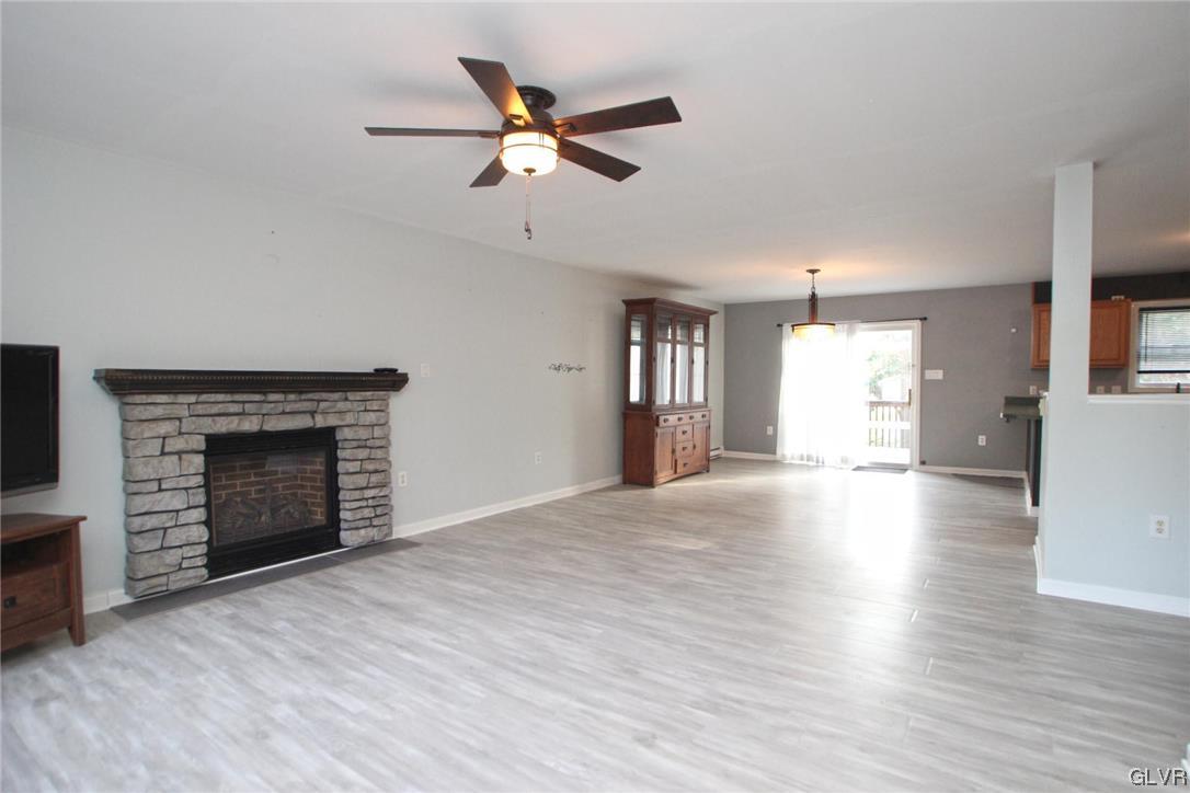 160 Spruce Drive Dingmans Ferry, PA 18328 - Photo 5 of 40 an empty room with windows and a fireplace