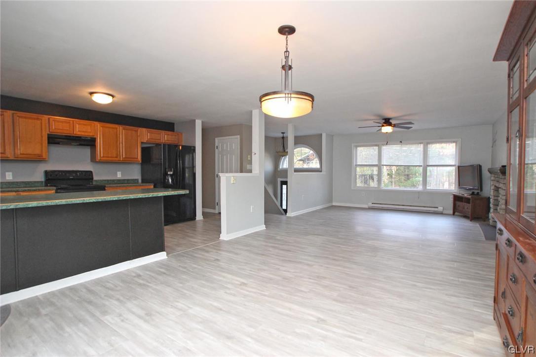 160 Spruce Drive Dingmans Ferry, PA 18328 - Photo 7 of 40 a view of a kitchen with a sink and dishwasher a refrigerator with wooden floor