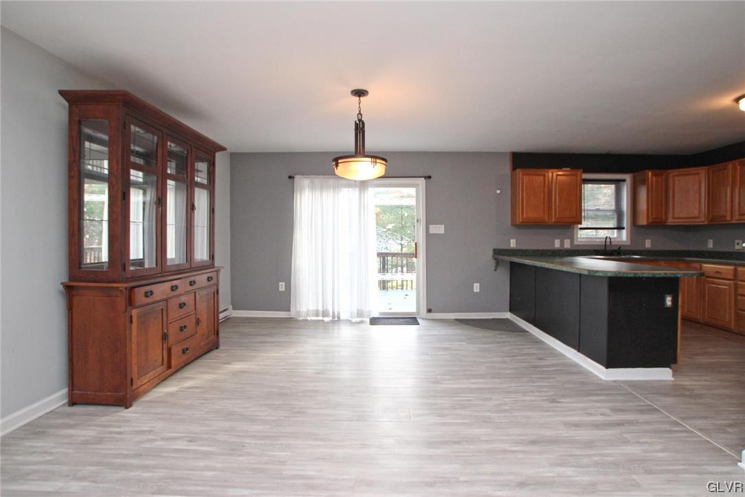 160 Spruce Drive Dingmans Ferry, PA 18328 - Photo 8 of 40 a kitchen with stainless steel appliances granite countertop a stove a sink and a wooden floors