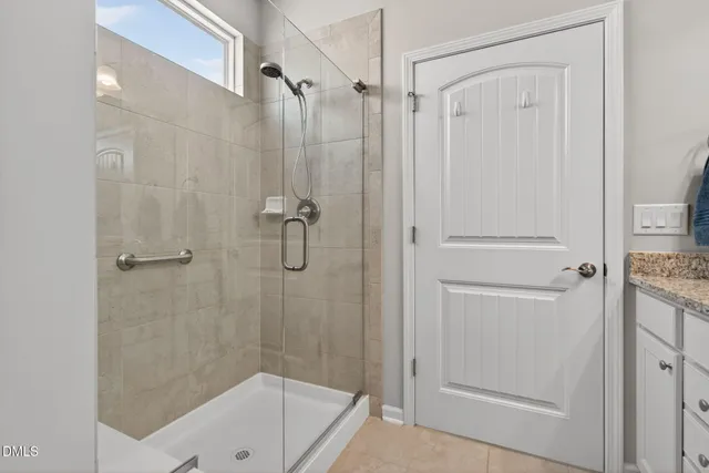 a bathroom with a shower and a bath tub