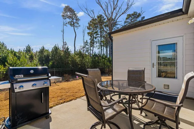 a view of a patio with a table and chairs