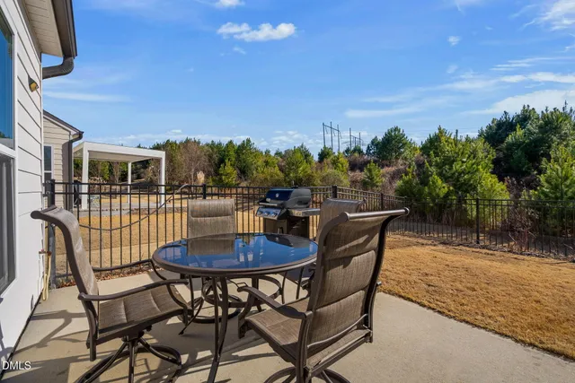 a view of a chairs and table in patio