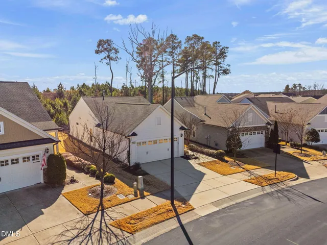 a view of a house with pool and sitting area