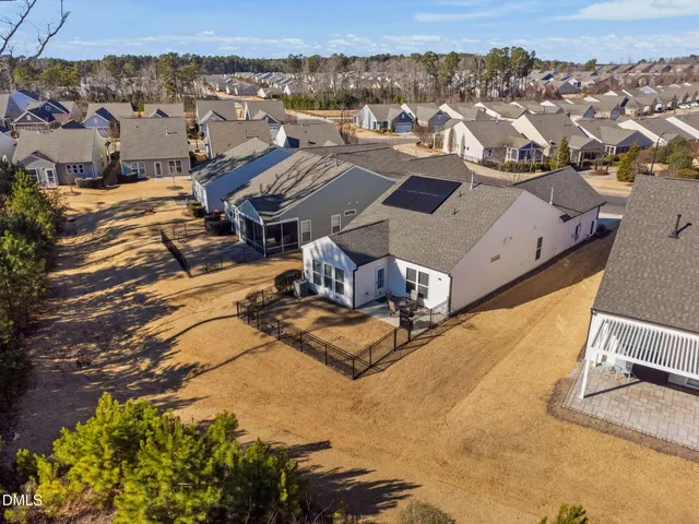 an aerial view of a residential houses with yard