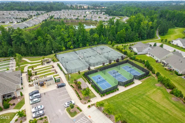 an aerial view of a house with a garden and lake view